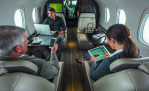 Passengers aboard a business aircraft, using SmartSKy's IFC service via their tablets