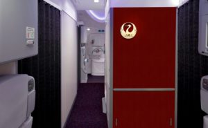 JAL Boeing 787 interior of the aircraft with red wall and JAL logo in gold