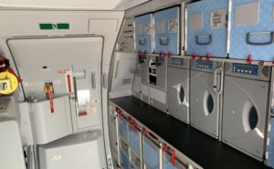 An aircraft galley with multiple galley inserts in view, as well as the exit door