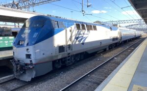 Amtrak blue and white train pulling into the station.