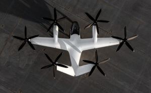 Joby eVOTL on landing pad. The aircraft is all white with black propellors