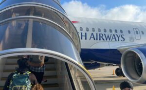 Passengers are boarding the BA A319 in the early morning hours.