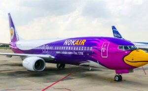 Nok Air aircraft all purple with the nose detailed in the likness of a bird