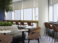 A brightly lit British Airways lounge with various seating options for passengers.