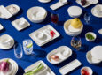 Armani/Casa Korean Air Prestige Class tableware is laid out on a blue table.