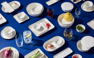Armani/Casa Korean Air Prestige Class tableware is laid out on a blue table.