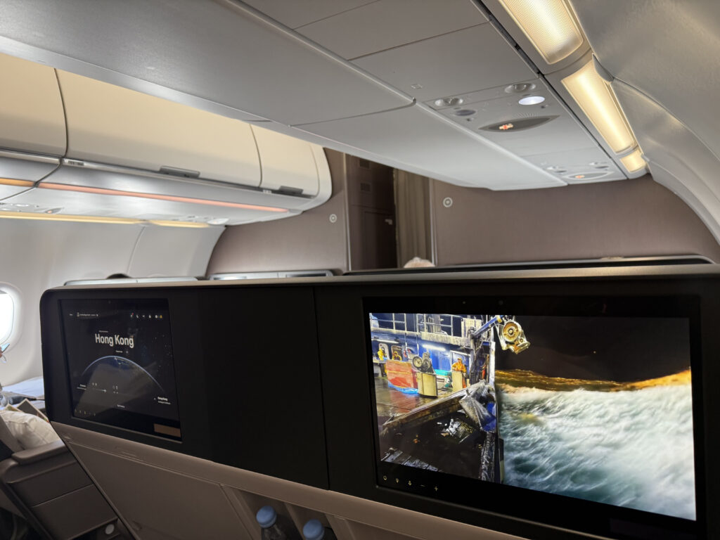 Large IFE screens are seen in the business class seats of the Cathay cabin