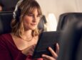 An American Airlines passenger is using the complimentary inflight Wi-Fi, as sponsored by AT&T.