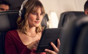An American Airlines passenger is using the complimentary inflight Wi-Fi, as sponsored by AT&T.